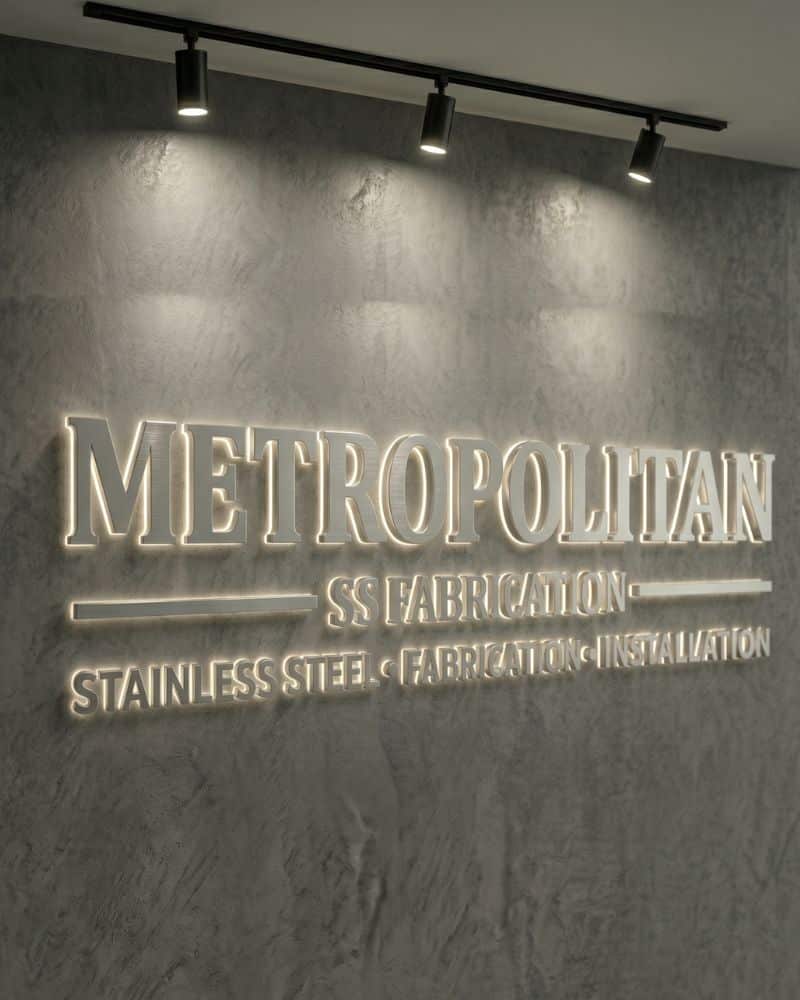Modern stainless steel sign for Metropolitan with illuminated lettering.